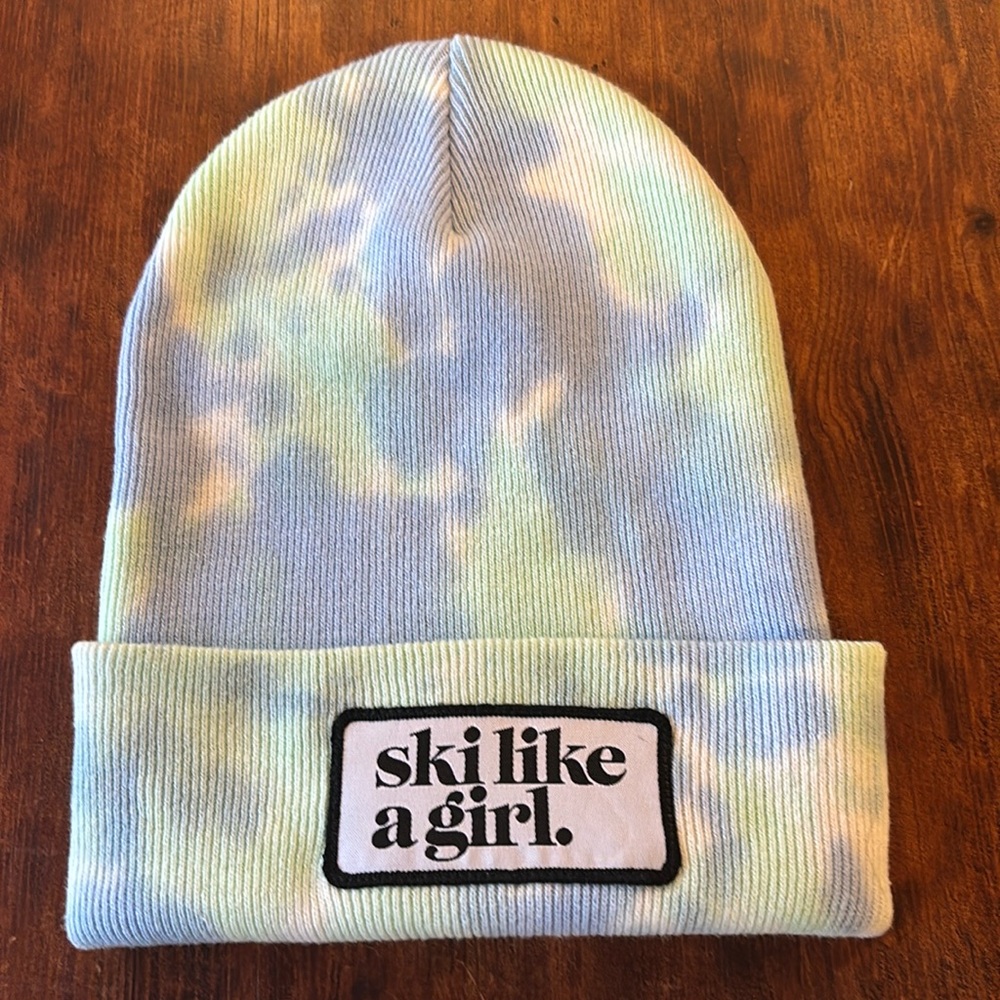 Woman’s Ski Like a Girl Patch Beanie.Fun blue green some pink tie-dye pattern.